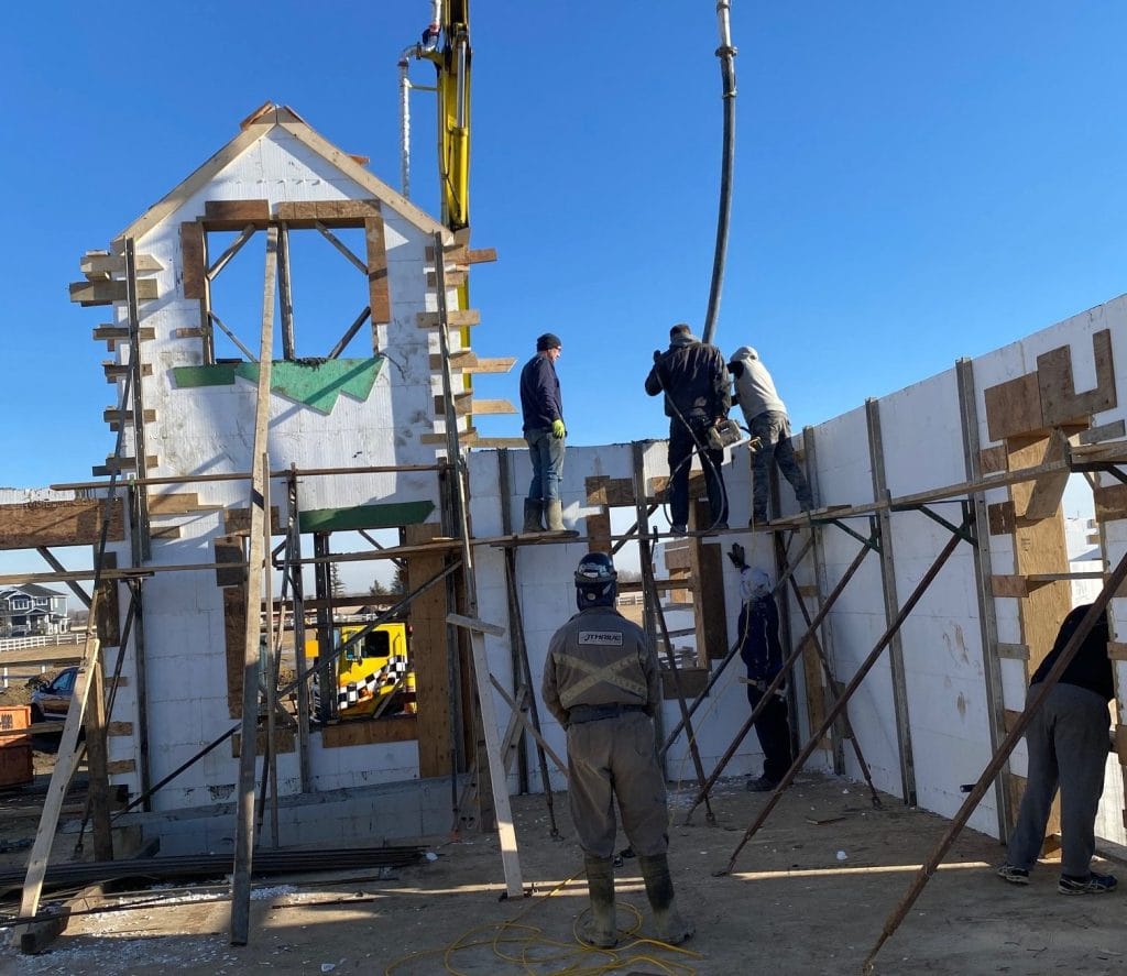 A crew of ICF Installers pouring concrete