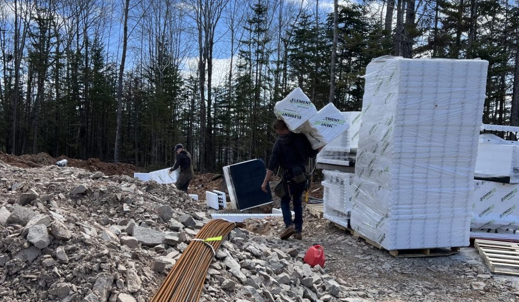 Installer carrying Element ICF blocks to build site.