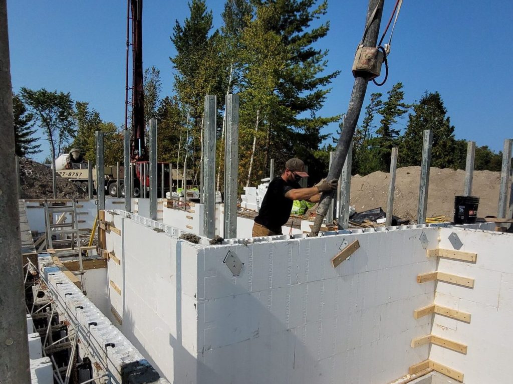 Builder pouring concrete into the Element ICF Foundation walls.