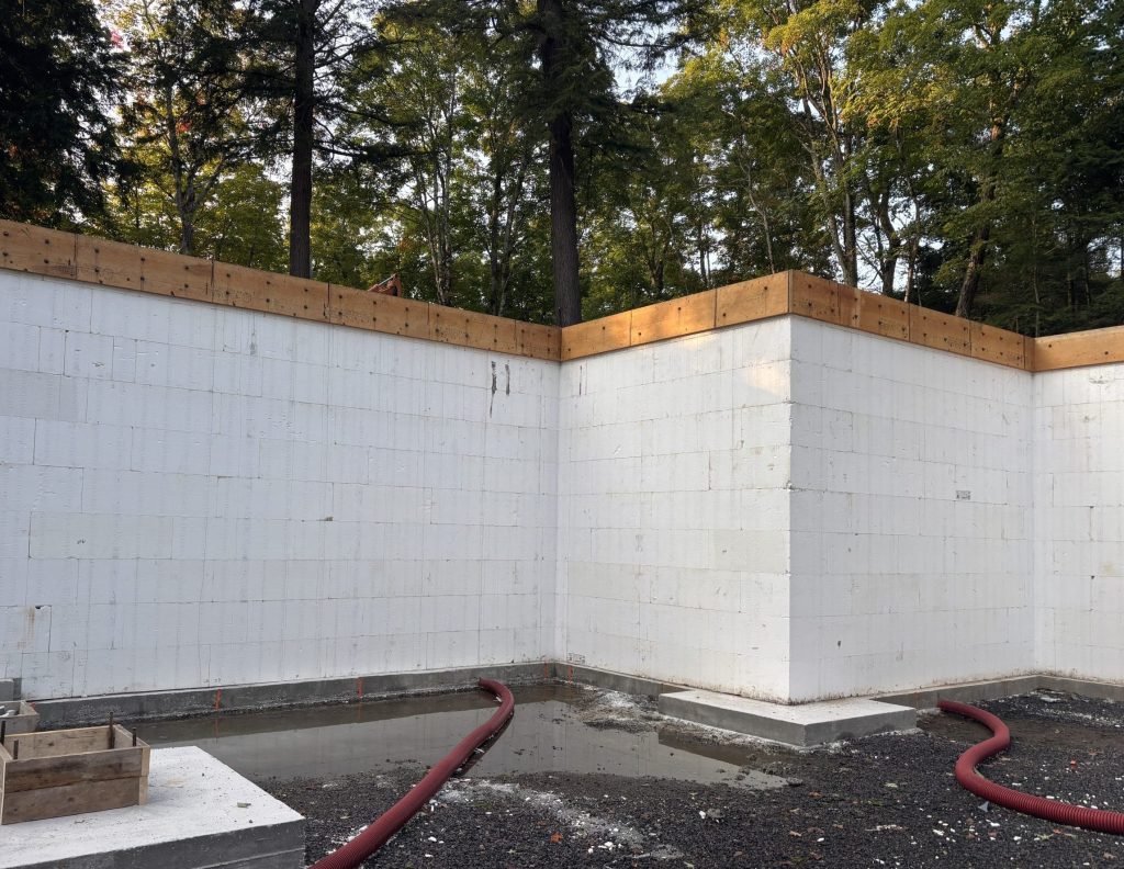 The completed pour reveals a straight, level rim joist — all bracing removed