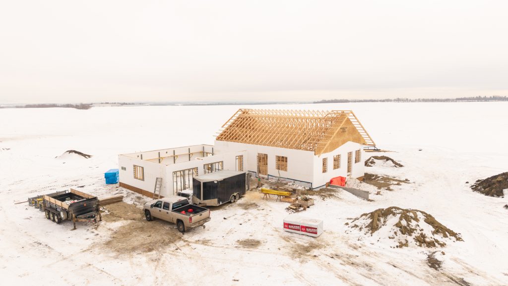 ICF walls complete with roof trusses in place. A standard top plate connection tied the truss system back to the ICF walls while maintaining enclosure continuity.