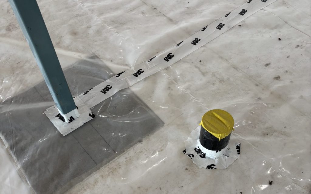 The radon vent is routed to the garage — preserving the basement slab air barrier
