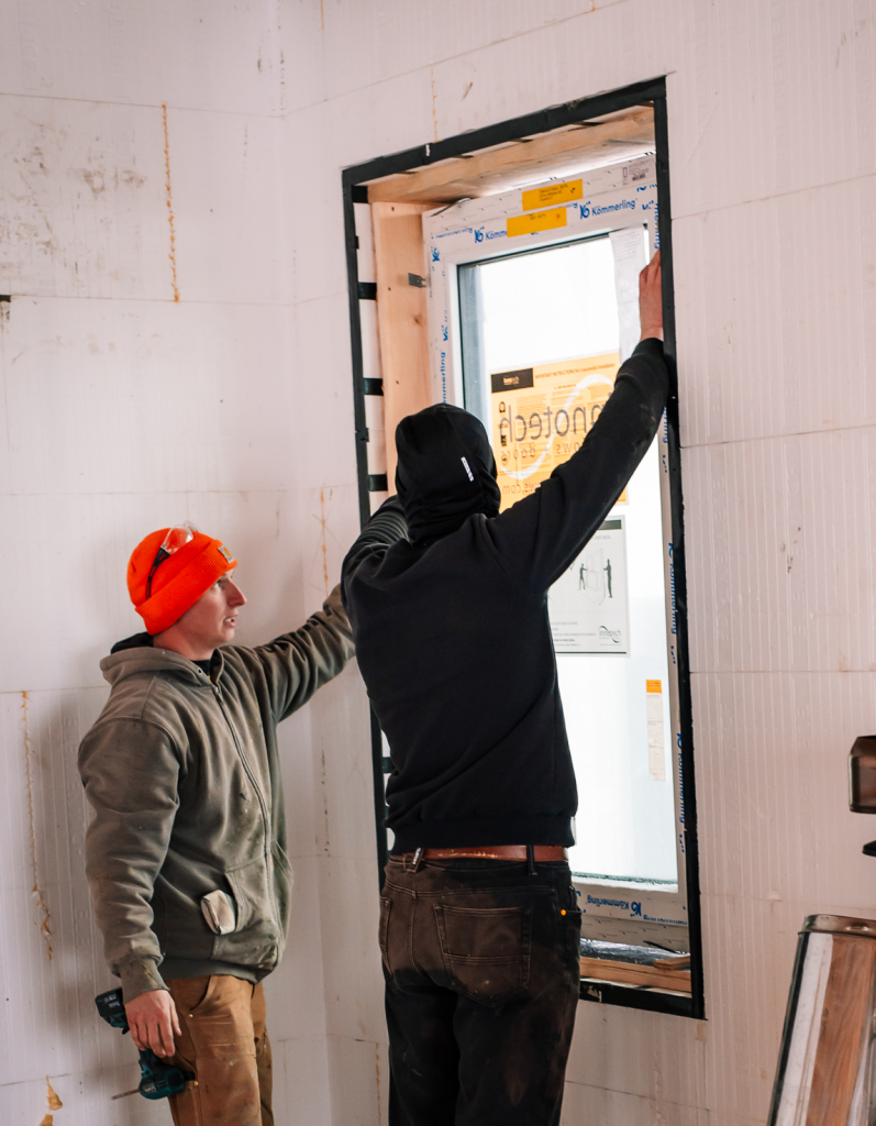 After the ICF wall was poured, a wood subframe was installed inside the ProBuck to create a precise mounting surface. The window is then positioned within this frame and sealed using tape and spray foam to connect the assembly back to the wall’s air control layer.